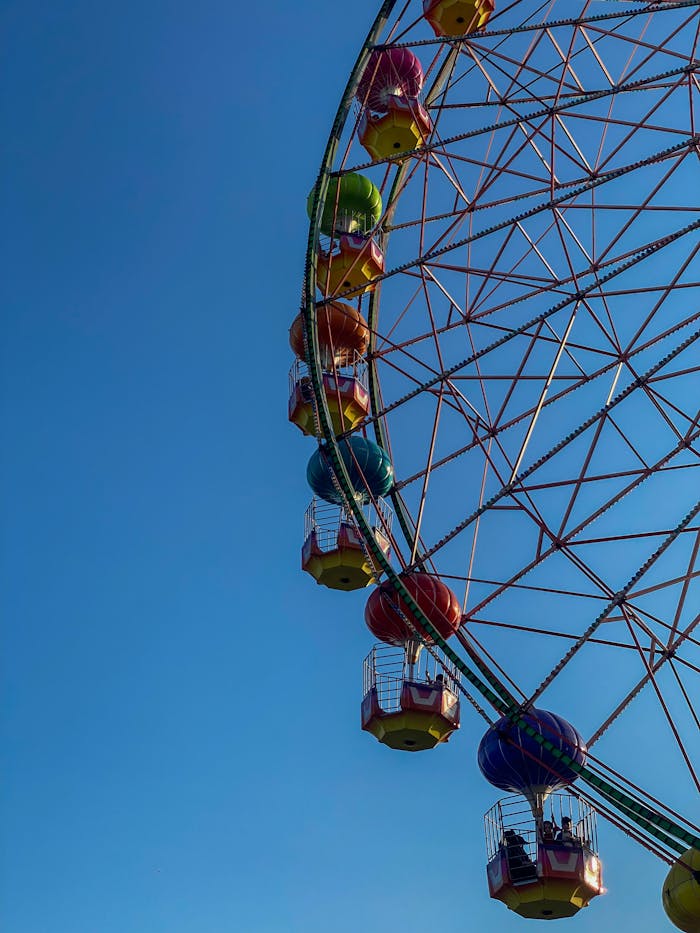 creative A vibrant ferris wheel soars against a clear blue sky, capturing the essence of amusement parks.