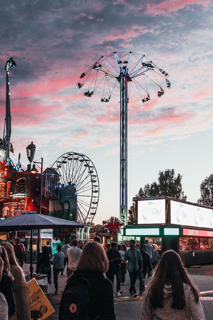 why-choose-us A lively scene at an amusement park during twilight with a dramatic sky and vibrant rides.